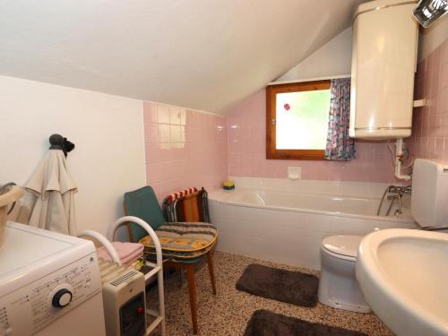 a bathroom with a sink toilet and a tub at Chalet Westermeyr in Mieming