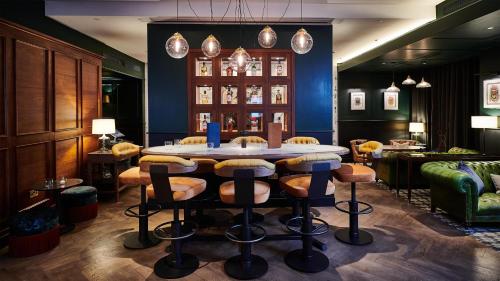 a room with a table and chairs in a room at Conrad London St James in London
