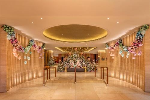 a hotel lobby with a christmas tree in the center at London Hilton on Park Lane in London