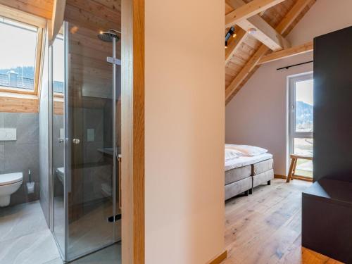 a bathroom with a shower and a bedroom at Mountain Chalet Berg-Glück in Sankt Lorenzen ob Murau