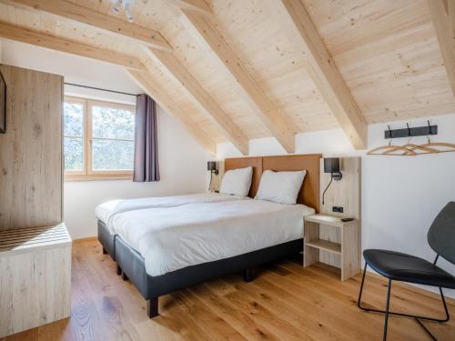a bedroom with a large bed and wooden ceilings at Sperlingnest in Donnersbachwald