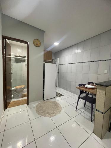 a kitchen with a table and a refrigerator at Apto do xavier III in Petrolina