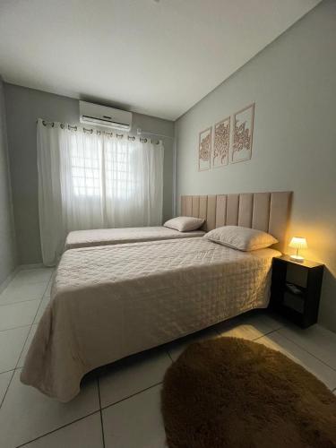 a bedroom with a large bed and a window at Apto do xavier III in Petrolina