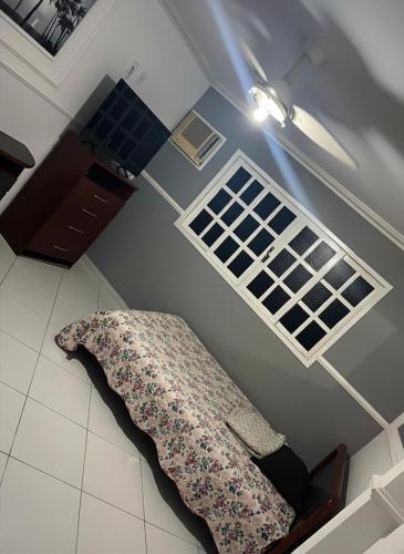 a room with a bed and a window on the floor at Casa Shekinah in Araruama