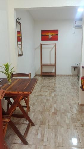 a room with a wooden table and a wooden floor at Flatmoitas in Amontada