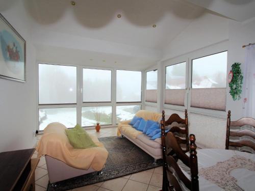 a bedroom with two beds and a large window at Mangartblick in Arriach