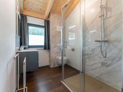 a bathroom with a glass shower and a toilet at Obermöschach 6 in Obermöschach