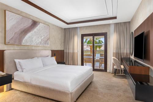 a hotel room with a bed and a television at Hilton Luxor Resort & Spa in Luxor