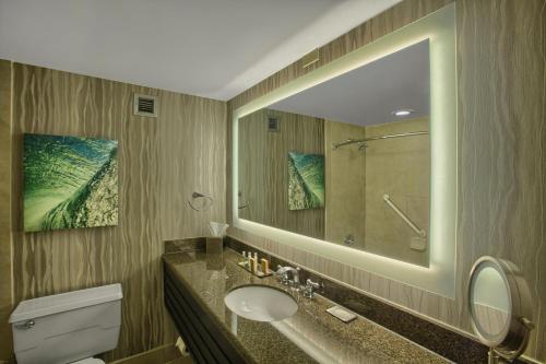 a bathroom with a sink and a mirror at DoubleTree by Hilton at the Entrance to Universal Orlando in Orlando