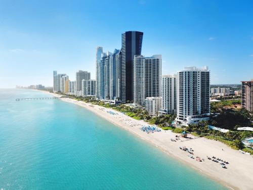an aerial view of a beach with tall buildings at DoubleTree by Hilton Ocean Point Resort - North Miami Beach in Miami Beach