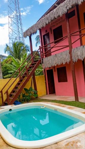 a house with a swimming pool in front of it at Flatmoitas in Amontada