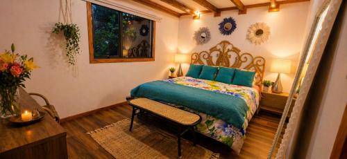 a bedroom with a bed and a chair in it at Casa Rosa in Coñaripe