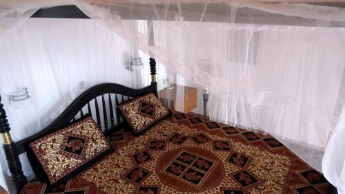 a bed with two pillows on top of it at Salt Lake Cabanas & Restaurant in Tangalle