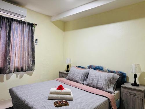 a bedroom with a bed with towels on it at Nadi Holiday House in Nadi