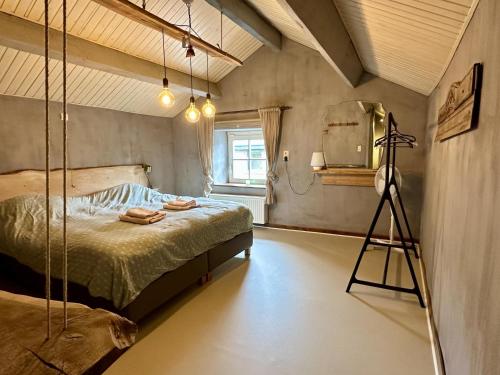 a bedroom with a bed and a tripod in it at Le Fournil in Manhay