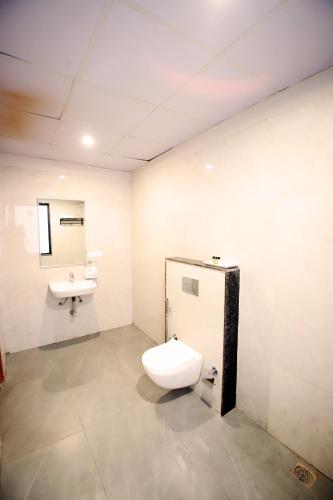 a bathroom with a toilet and a sink at Hotel Ember in Alwar