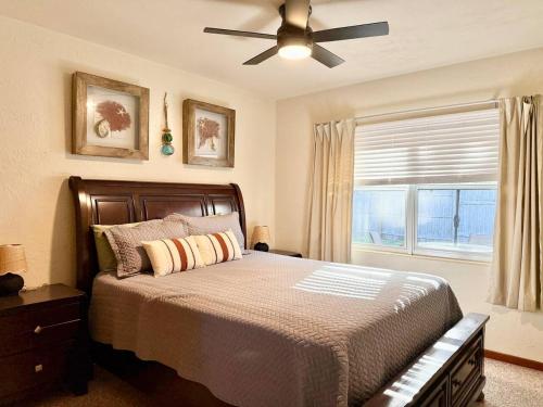 a bedroom with a bed with a ceiling fan and a window at Downtown Duplex A Amazing Location in Sanford