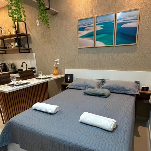 a bedroom with a blue bed with two pillows on it at VR VILLAGE - APT 02 - Studio completo próximo ao Shopping da Ilha in São Luís