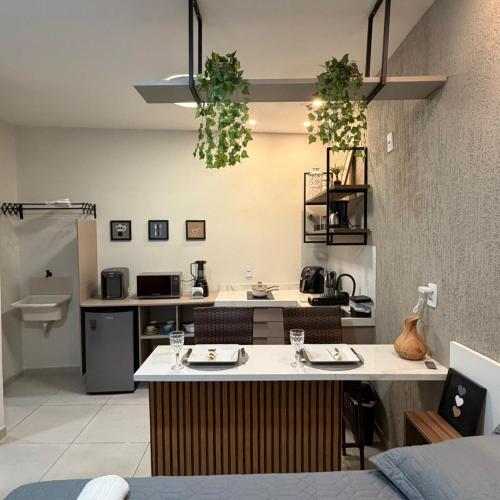 a kitchen with a table with two plates on it at VR VILLAGE - APT 02 - Studio completo próximo ao Shopping da Ilha in São Luís