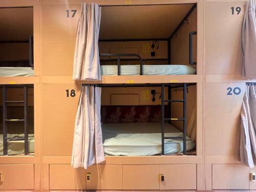 a bunk room with bunk beds in it at Urban Capsule by Faradale in Kuching