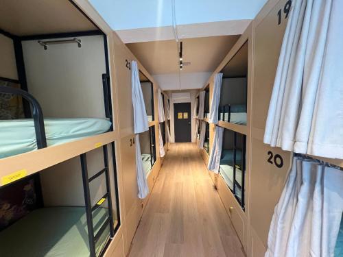 a corridor of a dorm room with bunk beds at Urban Capsule by Faradale in Kuching