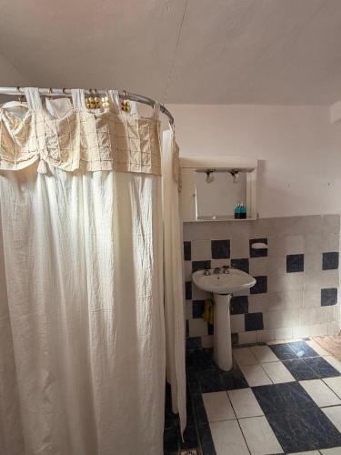 a bathroom with a shower curtain and a sink at Mis Montañas in Tinogasta