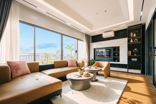 a living room with a couch and a large window at Santori studio Hanoi in Hanoi