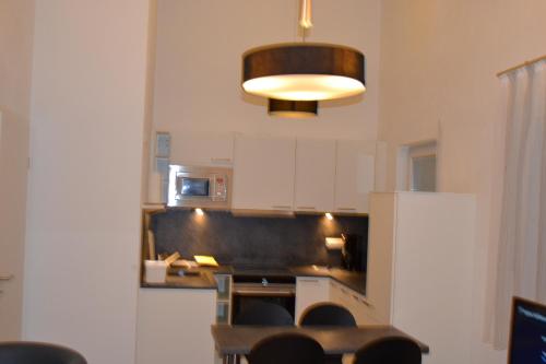 a kitchen with aendant light and a counter top at Aparthotel Sebastian in Erding