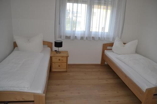 a bedroom with two beds and a window at Aparthotel Sebastian in Erding