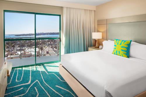 a hotel room with a large bed and a large window at Embassy Suites by Hilton San Diego Bay Downtown in San Diego