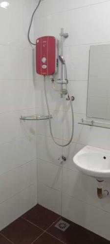 a bathroom with a shower and a sink at Elite Hotel in Kuantan