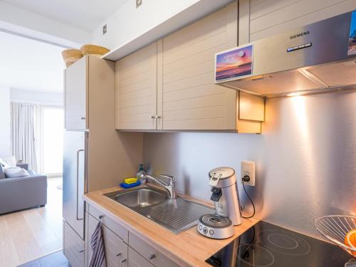 a kitchen with a sink and a coffee maker on a counter at Nautilus - 0301 in Westende-Bad