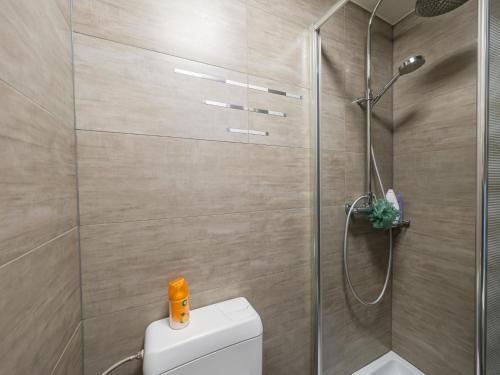 a bathroom with a toilet and a glass shower at Nautilus - 0301 in Westende-Bad