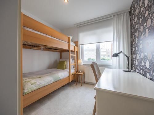a bedroom with a bunk bed and a desk at Rising Sun - 0101 in Westende-Bad
