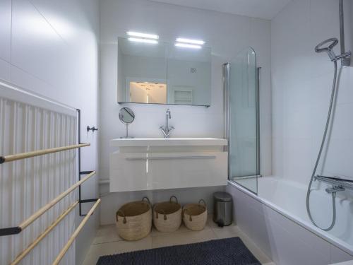 a white bathroom with a sink and a mirror at Rising Sun - 0101 in Westende-Bad