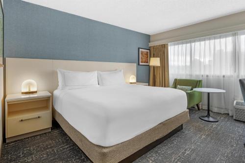 a bedroom with a large white bed and a desk at DoubleTree by Hilton Spokane City Center in Spokane