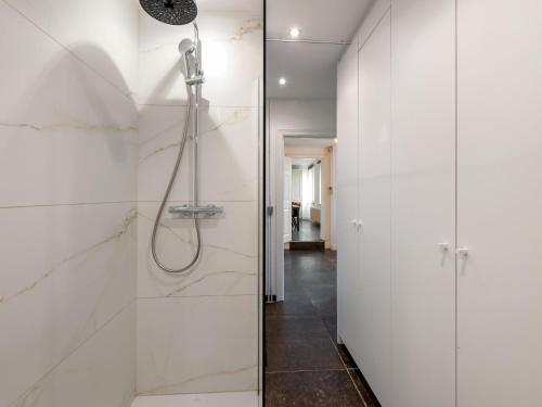 a bathroom with a shower with a glass door at Landhuis Brakelbos in Brakel