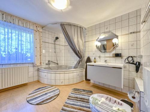 a bathroom with a tub and a sink at Vogel in Pirna