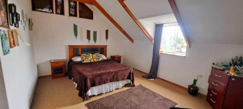 a bedroom with a bed and a window at Hare Te Maori in Hanga Roa