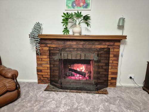 a fireplace in a living room with a fire place at Yarrawonga Holiday House with Open Fireplace in Yarrawonga
