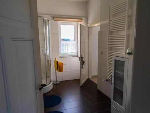 a bathroom with a walk in shower and a window at Brocken-Blick in Hüttenrode