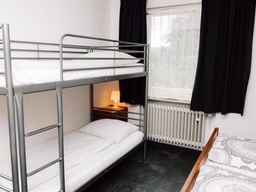 a room with two bunk beds and a window at Friedensthal in Bad Pyrmont