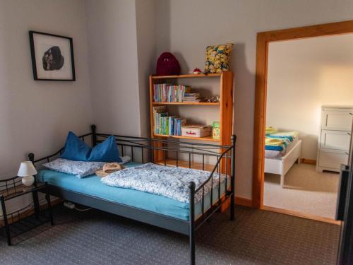 a bedroom with a bed and a book shelf at Brocken-Blick in Hüttenrode