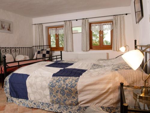 a bedroom with a large bed and windows at Weitblick in Zenting
