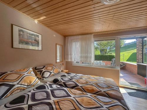 a bedroom with a large bed and a window at Talblick in Schönbrunn