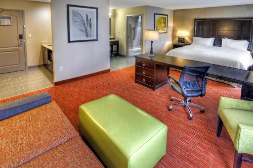a hotel room with a bed and a desk and chair at Hampton Inn and Suites Ada in Ada