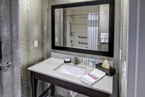a bathroom with a sink and a mirror at Hampton Inn and Suites Ada in Ada