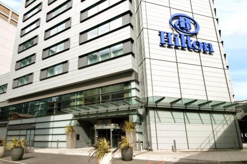 a rendering of the exterior of a high rise building at Hilton London Canary Wharf in London