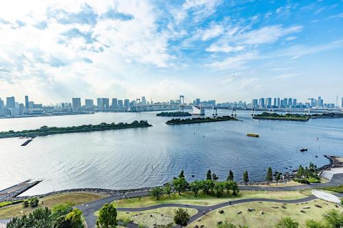 a large body of water with a city in the background at Hilton Tokyo Odaiba in Tokyo