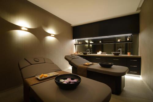 a room with two chairs and a table and a kitchen at DoubleTree by Hilton Wroclaw in Wrocław